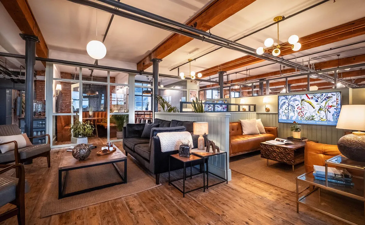 Lower lounge at Beehive Lofts with sofas and wooden beams