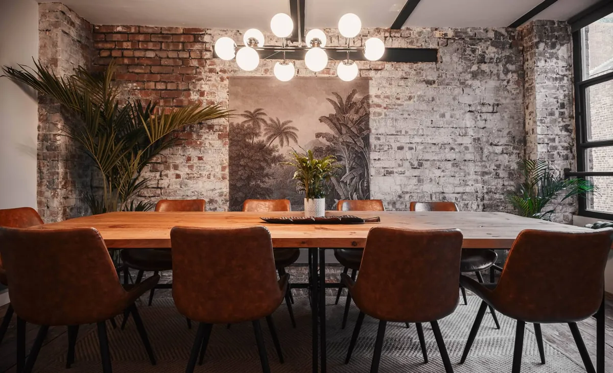 Meeting room with a long wooden table at Beehive Lofts, Manchester